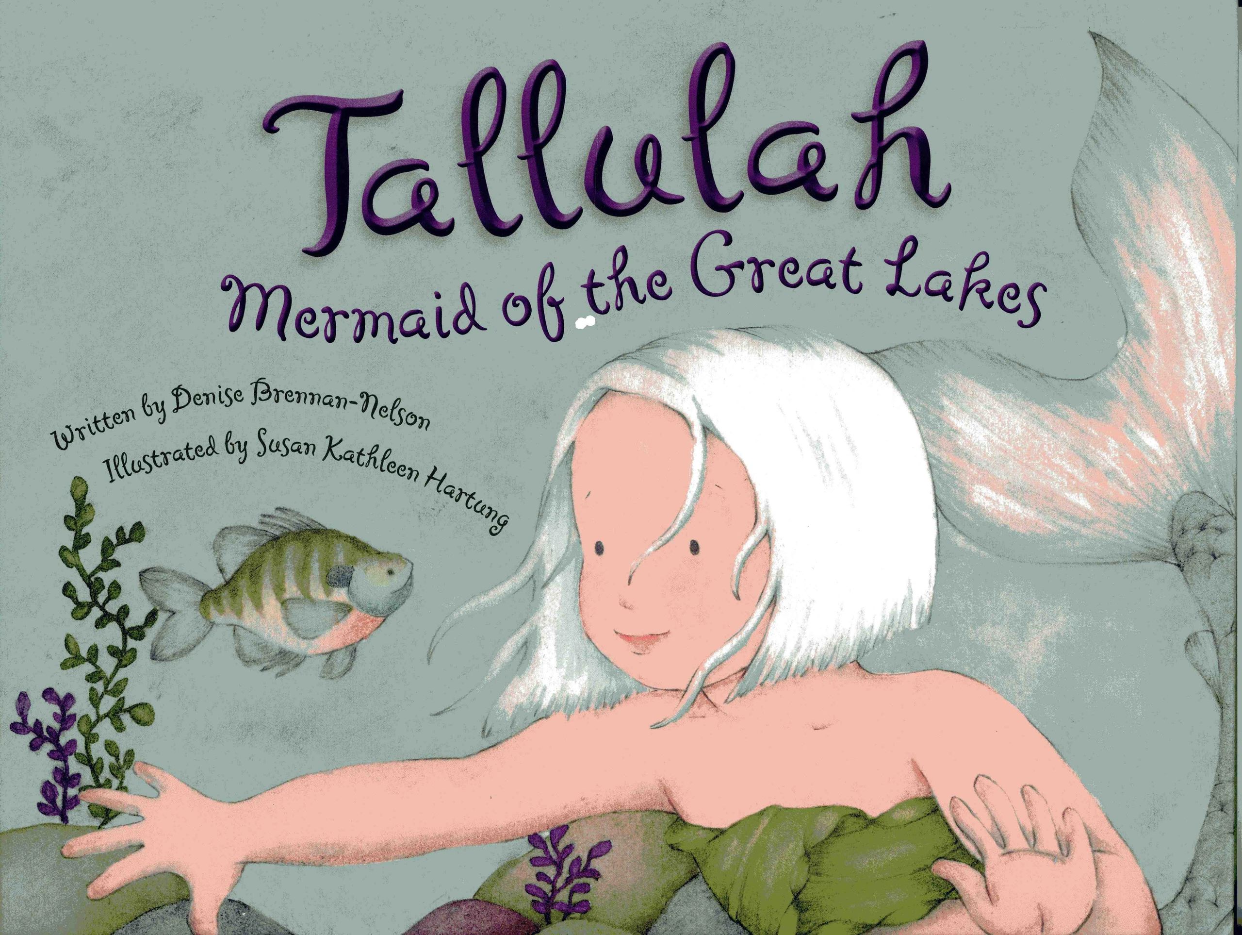 Mermaid swimming with fish in underwater scene.