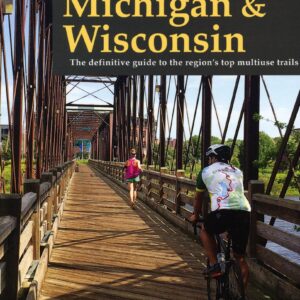 Cyclists on a scenic rail-trail bridge.