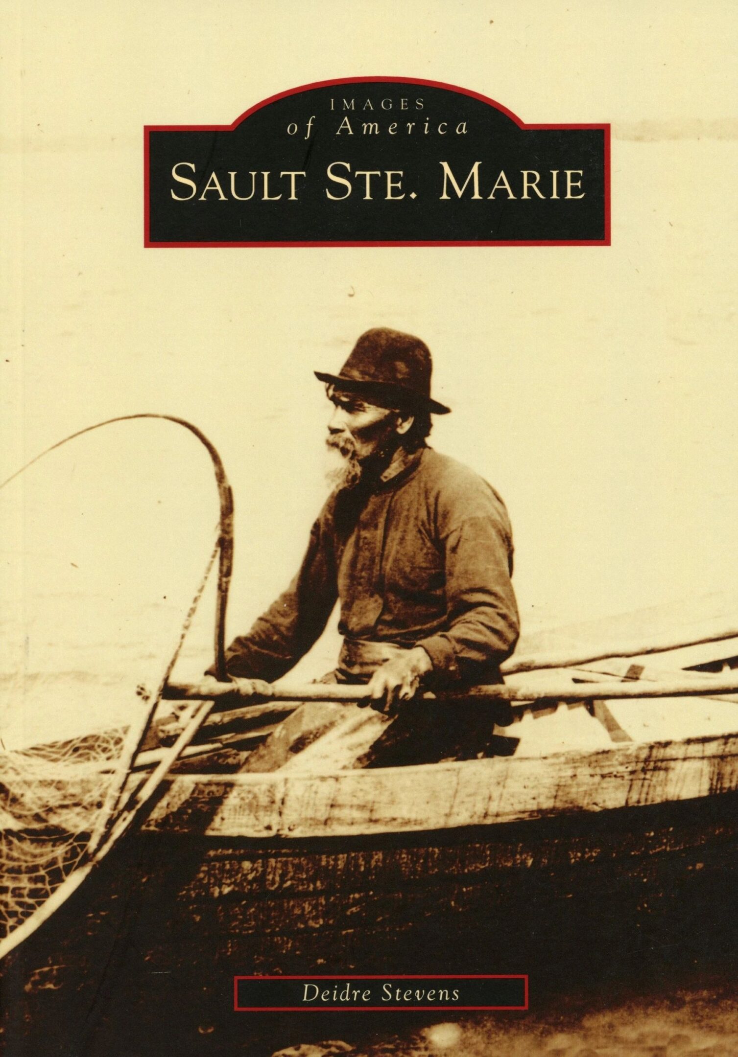 Man fishing from a wooden boat.