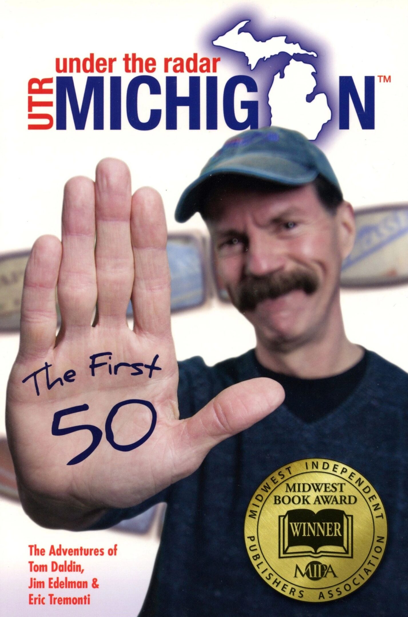 Man holding hand up, "The First 50".