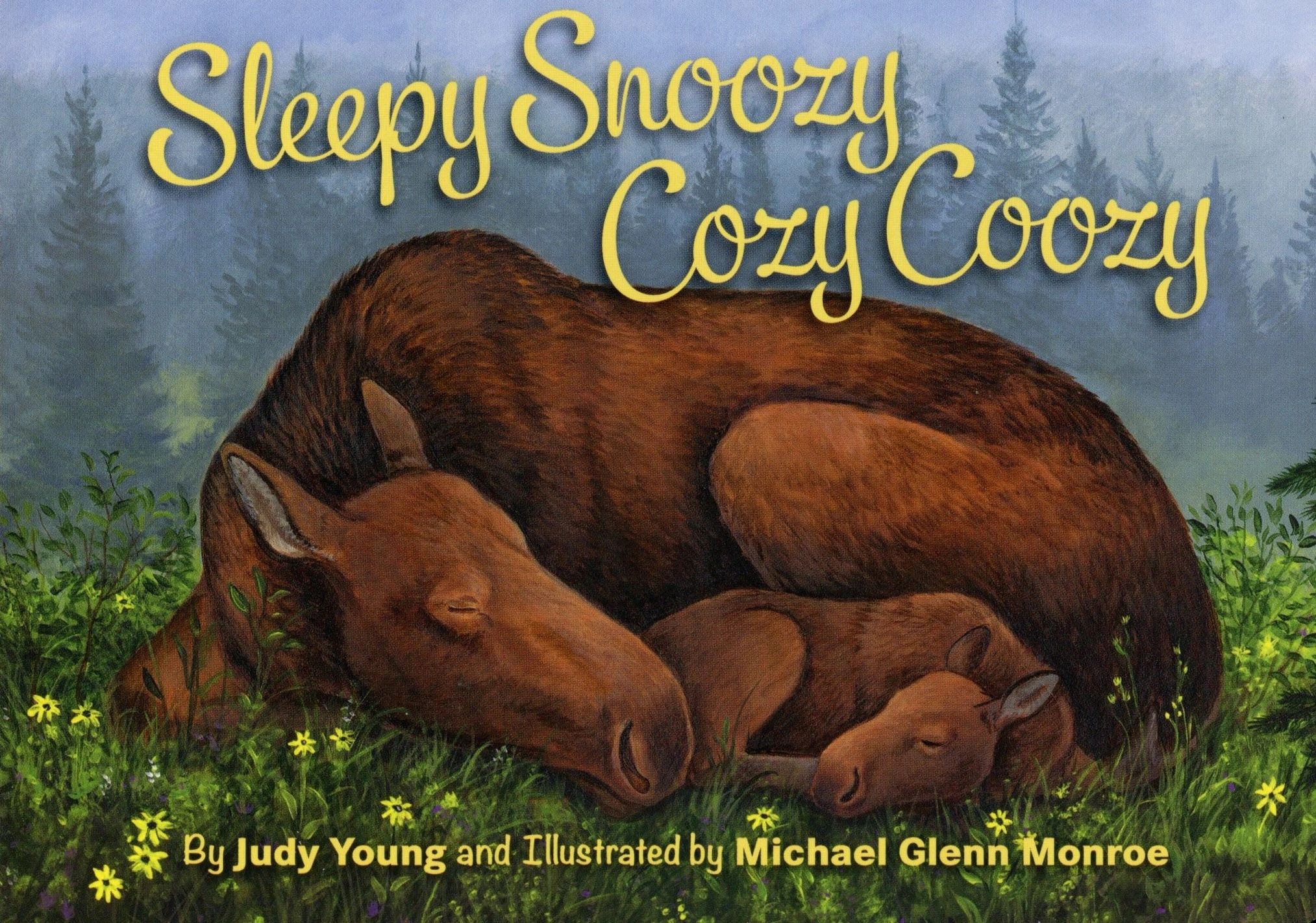 Moose and calf sleeping in a forest.