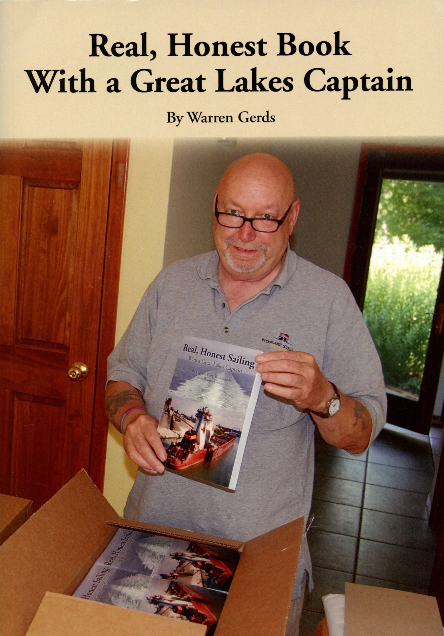 Man holding a book about Great Lakes sailing.