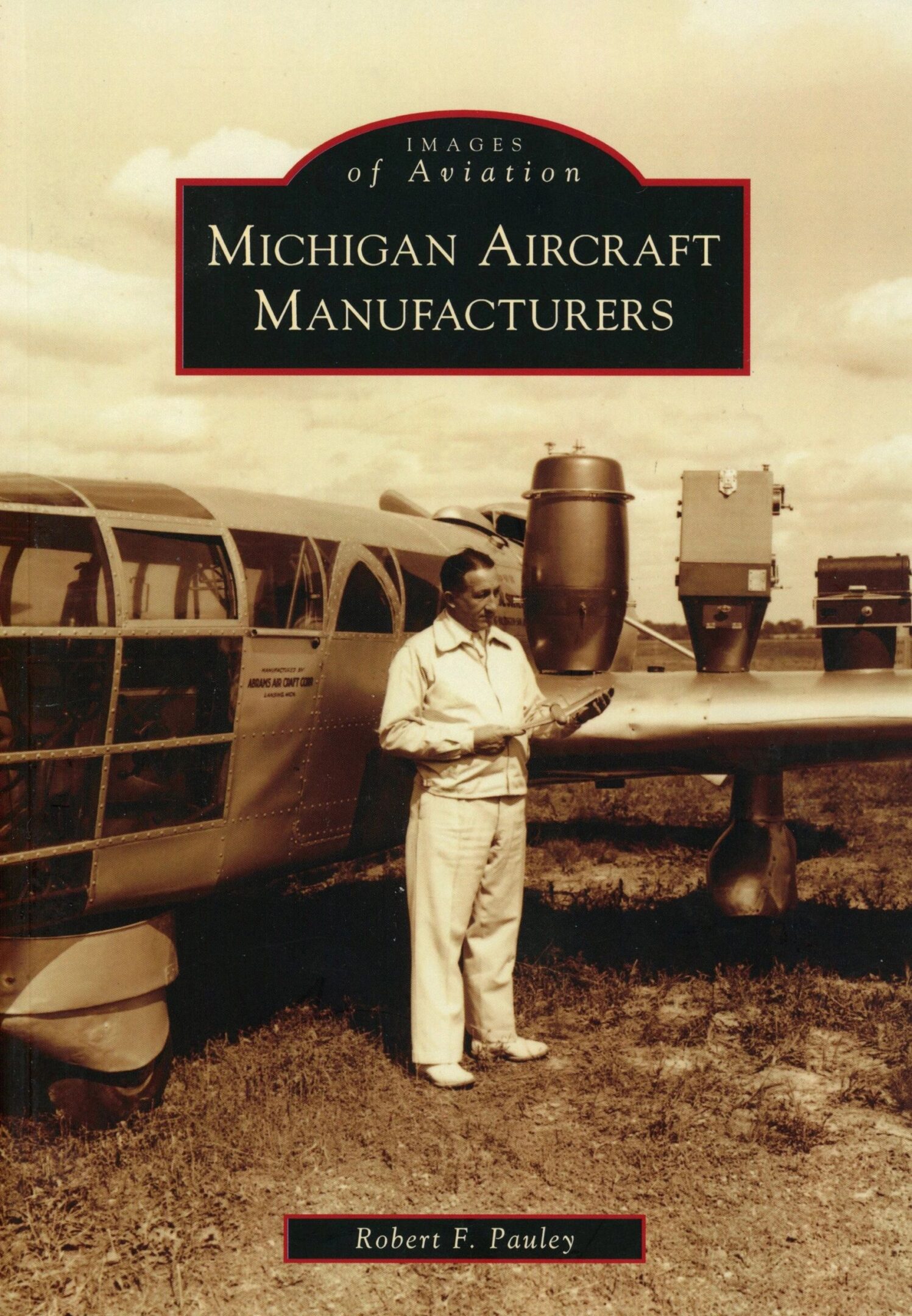 Man standing by vintage aircraft, sepia tone.